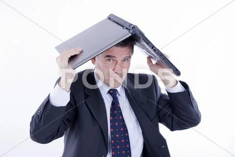 Businessman, 50+, holding a laptop above his head Stock Photos