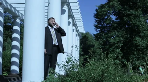 Businessman accepting a phone call he is happy Stock Footage 59087928