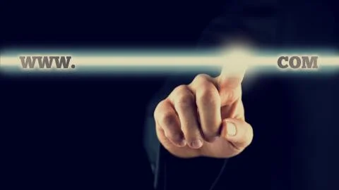 Businessman activating a www.com button on virtual screen Photos