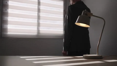 Businessman adjusting window blind with moving sunlight in office Stock-Footage 330998361