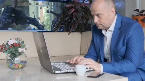 Businessman after work is viewing information from a laptop. Stock Footage 107781757