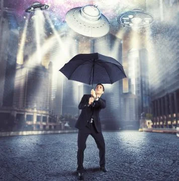 Businessman against alien attack Stock Photos