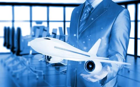 Businessman with airplane over his hand Illustrazione stock