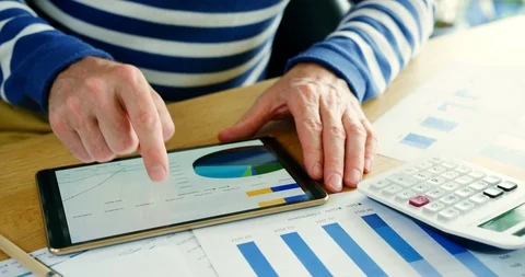 Businessman Analysing Financial Data Using A Digital Tablet Stock Footage 100045772