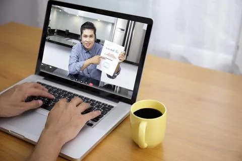 Businessman analysis financial chart with videoconference online meeting. Han Stock Photos