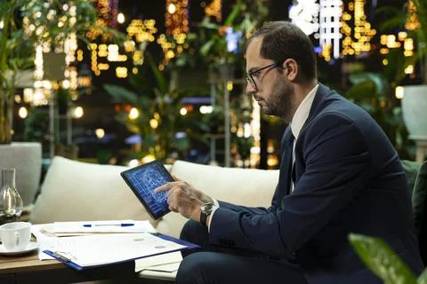 Businessman analyzes artificial intelligence interface on tablet 스톡 사진