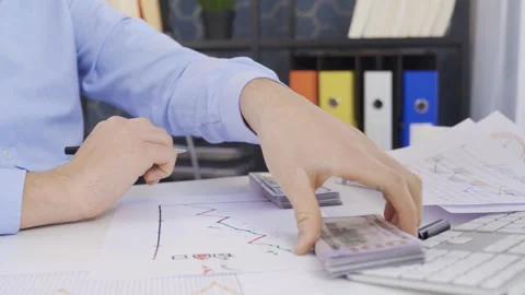 Businessman analyzing and plotting business growth and earnings rise graph. Stock Footage 220642294