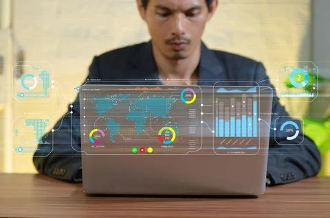 Businessman Analyzing Data with Digital Interface on Laptop Display Stock Photos