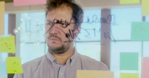 Businessman Analyzing Data on Glass Wall in Office Видео 324571795