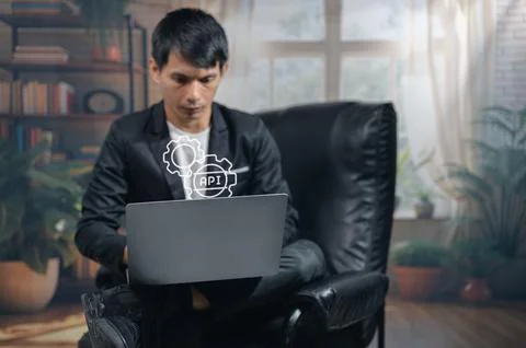 Businessman Analyzing Data on Laptop in Modern Office with Virtual Icons Фото