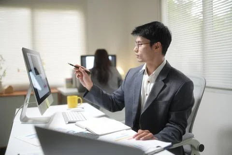 Businessman Analyzing Data on Office Computer Stock Photos