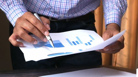 Businessman analyzing financial data at office desk Stock Footage 131133607