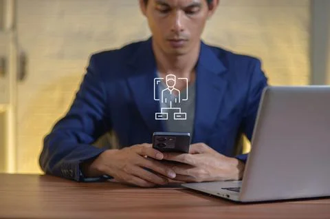Businessman Analyzing Flow Chart on Smartphone in Office Setting Stock Photos