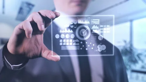 A businessman is analyzing infographics on a device of the future. Stock-Footage 119701516