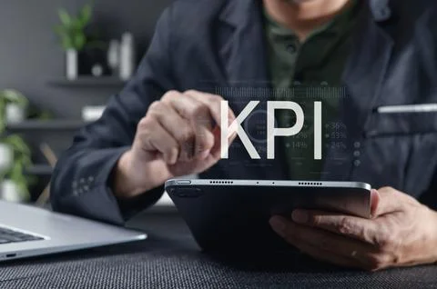 Businessman Analyzing Key Performance Indicators on Tablet Device Stock Photos