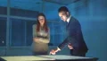 The businessman and a businesswoman discussing near the virtual screen 4k or 4k+ Resolution