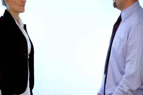 Businessman and businesswoman shaking hands, isolated Stock Footage