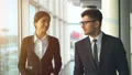 The businessman and a businesswoman walking in the office. slow motion HD Footage