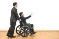 The businessman and a disabled gesture on the white wall background Photo
