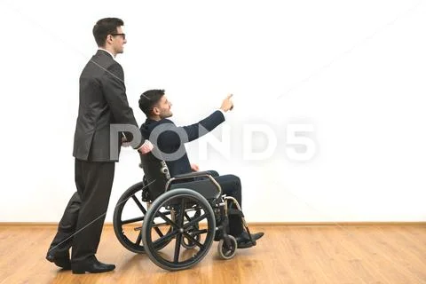 The businessman and a disabled gesture on the white wall background Stock Photos