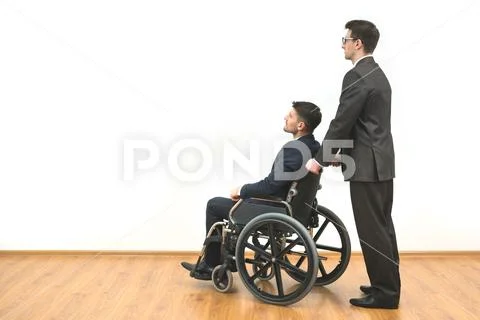 The businessman and a disabled stand on the white wall background Stock Photos