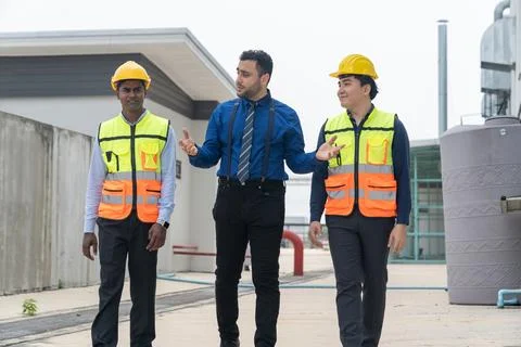 Businessman and engineer talking while walking at construction site. Foto stock