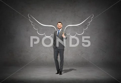 Businessman with angel wings showing thumbs up Stock Photos