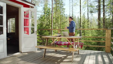 Businessman answering phone callwhile working remotely in countryside Stock Footage 195358352