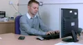 Businessman answers phone at work HD Footage