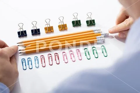 Businessman Arranging The Pencils In Between Colorful Pins Stock Photos