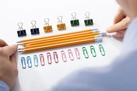Businessman Arranging The Pencils In Between Colorful Pins Stock Photos