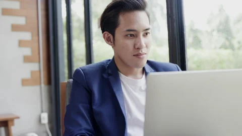 Businessman Asian sitting at work use laptop to talk video call with colleagues. Stock Footage 146371503