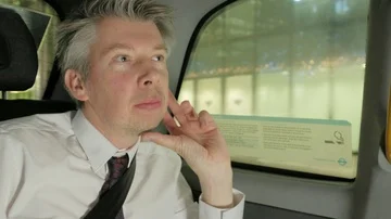 Businessman in the back of a taxi cab at night Video stock 85631353