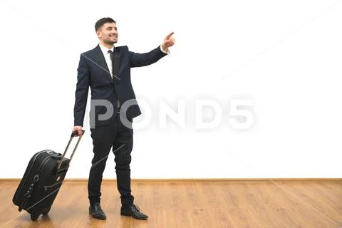 The businessman with a bag gestures on the white wall background Stock Photos