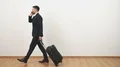 The businessman with a bag phoning on the white wall background 4k or 4k+ Resolution