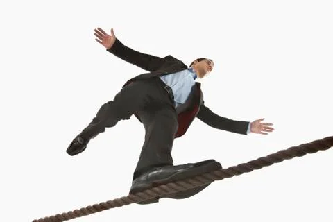 Businessman balancing on tightrope Stock Photos