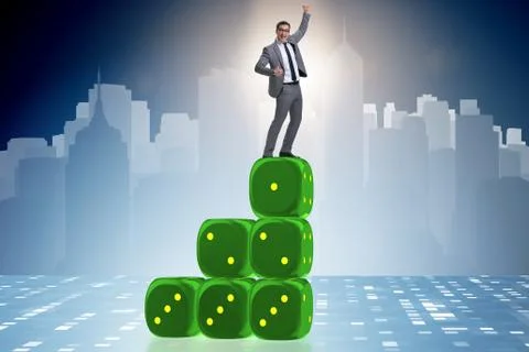 Businessman balancing on top of dice stack in uncertainty concep Stock Photos