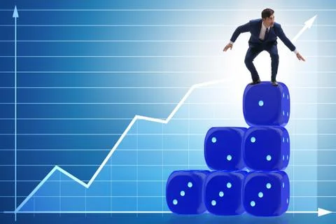 Businessman balancing on top of dice stack in uncertainty concep Stock Photos