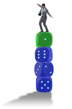 Businessman balancing on top of dice stack in uncertainty concep Stock Photos