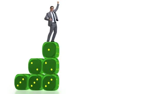 Businessman balancing on top of dice stack in uncertainty concep Stock Photos