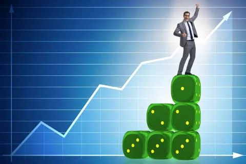Businessman balancing on top of dice stack in uncertainty concep Stock Photos