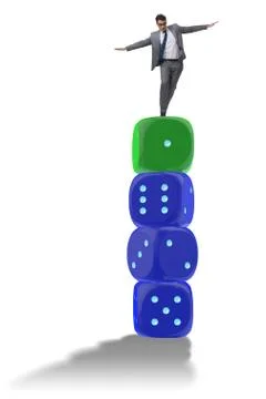 Businessman balancing on top of dice stack in uncertainty concep Stock Photos