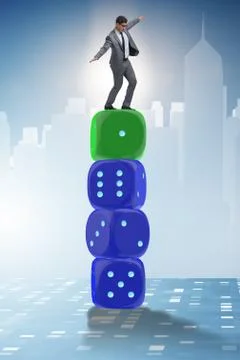 Businessman balancing on top of dice stack in uncertainty concep Stock Photos