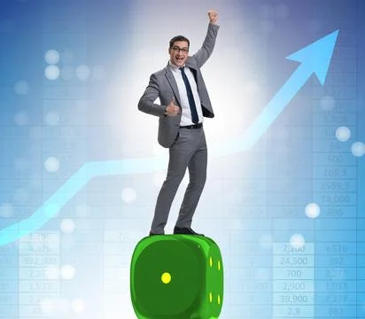 Businessman balancing on top of dice stack in uncertainty concep Stock Photos