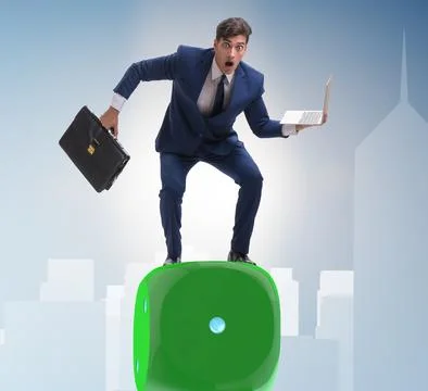 Businessman balancing on top of dice stack in uncertainty concep Stock Photos