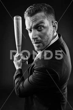 Businessman with baseball bat in hands, aggression concept. Bearded man in Stock Photos