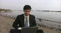 Businessman at the beach. HD Footage
