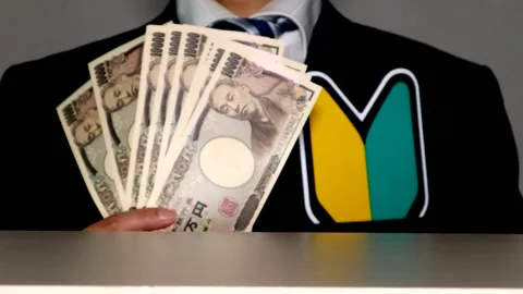 A businessman with a beginner driver's sticker and banknotes Stock Footage 334978671