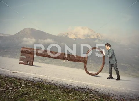 Businessman with big key to success Stock Photos