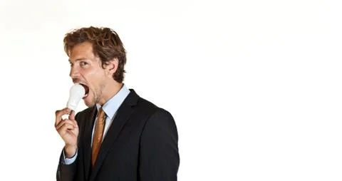 Businessman biting lightbulb Stock Photos